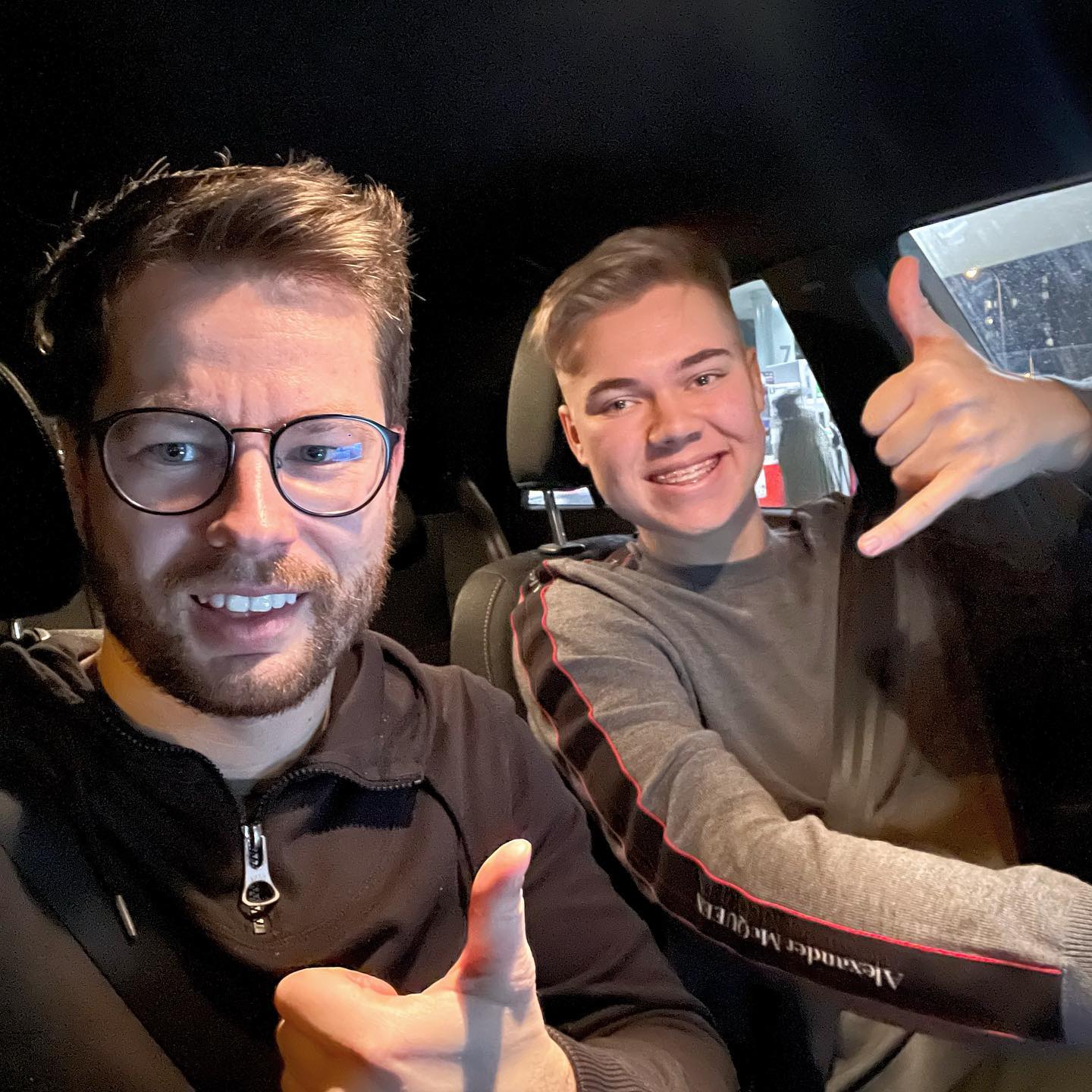 Instruktor i kursant w samochodzie, instruktor pokazuje palcem OK